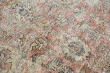 Distressed vintage Mahal carpet detail: worn Herati pattern, exposed knot heads in muted dusty rose.
