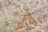 Vintage Mahal carpet detail: distressed Herati motif in dusty rose, ivory, and soft blue.