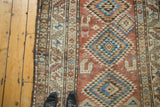 Vintage Kurdish rug field with geometric medallions, animal figures, sky blue, apricot, brown.
