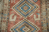 Kurdish runner detail: stylized woven animal and geometric patterns in apricot, sky blue, and antique ivory.