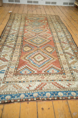 Vintage Kurdish rug runner's end border showcasing a sky blue band and intricate geometric patterns.