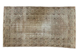 Distressed vintage Malayer carpet featuring faded intricate Herati field and soft silver, blush, brown tones.