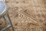 Distressed Malayer carpet with intricate stepped patterns, pale blush, antique ivory, and chocolate brown tones.