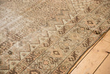 Distressed vintage Malayer carpet, featuring sharp stepped patterns and worn ivory, blush, chocolate tones.