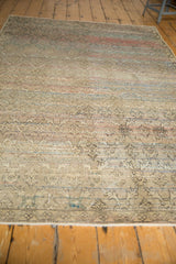 Vintage distressed Oushak rug's low pile texture with faint trellis and poly-chromatic tones.
