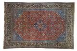Vintage Qashqai rug with sapphire blue medallion, ruby red field, intricate Herati florals.