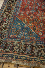 Ruby red, sapphire blue, and bronze charcoal intricate floral motifs with fringe detail.