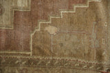 Stepped geometric motif and abrashed field in mauve, dusty plum, and sand tones.