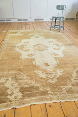 Distressed texture, abrash, and geometric border of a vintage Oushak rug.