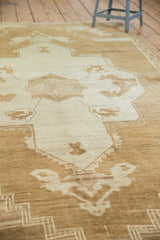 Textured distressed Oushak rug pile with primitive rose drawing and pale bronze abrashes.
