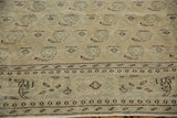 Distressed Oushak rug detail: ivory and seafoam green boteh pattern, chocolate tones. Mostly even wear to knot heads.