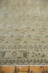 Distressed Oushak carpet pile featuring worn linear boteh design in antique ivory, pale dusty green.