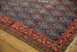Malayer runner's intricate tomato red border and navy blue field with boteh design.