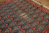 Vintage Malayer rug with low pile and foundation visible through navy boteh motif.