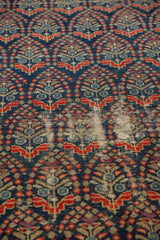 Vintage Malayer runner's navy, red, and ivory boteh design showing low pile and foundation.