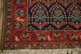 Vintage Malayer rug corner, featuring tomato red border, dark selvedge, and ivory fringe.