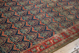 Vintage Malayer runner's low pile, visible foundation, and red boteh on navy field.