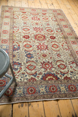 Distressed vintage Kayseri rug featuring faded red floral palmettes and a traditional multi-band border.