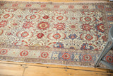 Distressed vintage Turkish Kayseri rug corner, showing red palmettes and floral border.
