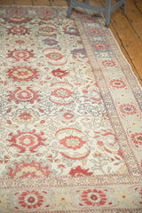 Distressed ivory field of vintage Kayseri rug, with cinnabar palmettes and subtle Herati motifs.