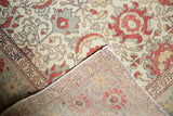 Kayseri rug folded to reveal distressed ivory palmettes and hand-knotted reverse.