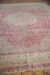 Detail of distressed Sivas carpet showing faded fuchsia and ivory sprawling vinery.