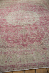 Faded fuchsia and ivory vinery pattern on distressed Sivas rug, with exposed foundation.