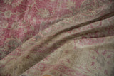 Distressed texture and faded fuchsia on a vintage Sivas carpet, with foundation visible.