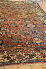 Vintage Malayer carpet corner with madder root red floral pattern, beige border, and soft patina.