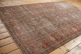 Distressed Mahal carpet edge, showing muted red Herati pattern and visible foundation texture.