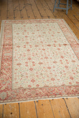Distressed vintage Turkish Kayseri rug, intricate ivory floral design, blush and cochineal red.