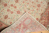Distressed hand-knotted Kayseri rug's corner showing intricate floral pile and woven foundation.