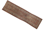 Antique Kurdish runner with faded palmette medallions in muted tones, showing mostly even wear.