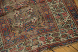 Antique Kurdish runner border with faded raspberry red, ivory geometric patterns, and visible foundation wear.