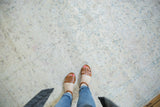 Subtle ivory and pale blue floral patterns on a distressed vintage Sivas carpet.