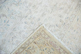 Distressed ivory and pale blue floral Sivas carpet pile, woven foundation, and fringe.