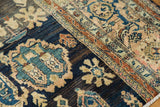 Antique Persian runner showing navy, sky blue, dusty blush floral palmettes and a fine border.