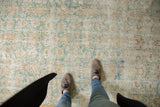 Distressed texture of vintage Sivas rug, with faded seafoam green and ivory floral blossoms.