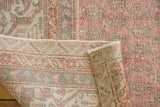 Vintage distressed Sivas carpet's hand-knotted back and secured edge with blush rose pile.