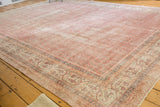 Distressed vintage Sivas carpet featuring faded blush rose boteh field and antique ivory border.