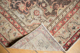 Distressed Oushak rug pile showing wear and its hand knotted reverse foundation.