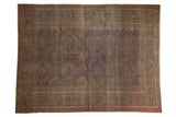 Antique Persian Belouch carpet, chestnut brown field, red and navy oversized serrated gul motifs with even wear, 6'2
