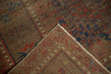 Antique Belouch carpet corner, featuring hand-knotted pile, red, navy gul motifs, and ivory fringe.