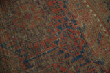 Close-up of antique Belouch carpet with sharp serrated gul motifs and subtle aged pile.