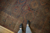 Antique Persian Belouch carpet: faded chestnut, red, navy gul motifs, mostly even wear to foundation.