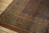 Antique Belouch carpet detail revealing mostly even wear, serrated red and blue geometric motifs.