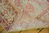 Distressed Oushak rug corner showing faded blush pile, original selvage, and reverse weave.