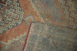 Distressed Oushak rug pile with visible wear, showing woven foundation and fringe.