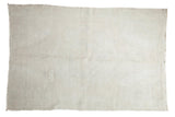 Distressed vintage Oushak rug with a subtle pattern and soft ivory, white, and gray texture.