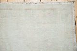 Woven reverse of vintage Oushak rug, showing foundation, knot heads, and pink markings.
